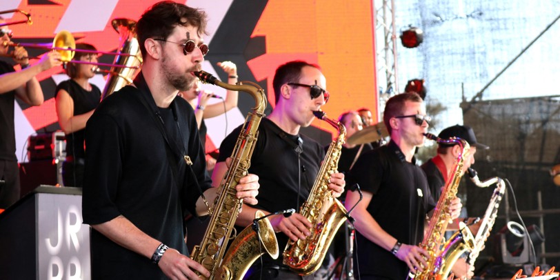 Horn section playing on stage